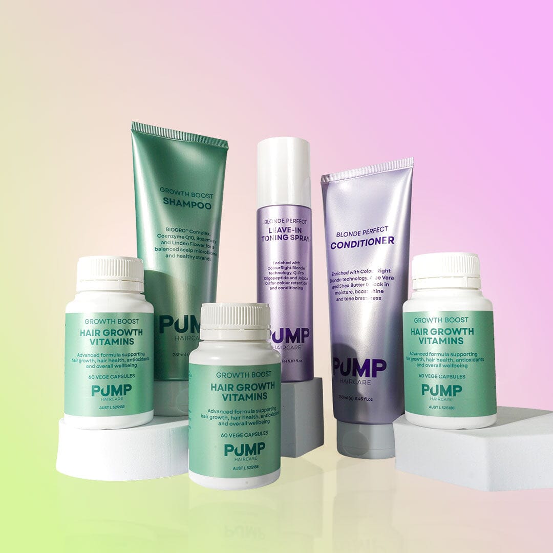 A set of hair growth products from PUMP Growth Body, including shampoo, conditioner, a spray, and two supplement bottles, arranged on white pedestals against a pastel gradient background.
