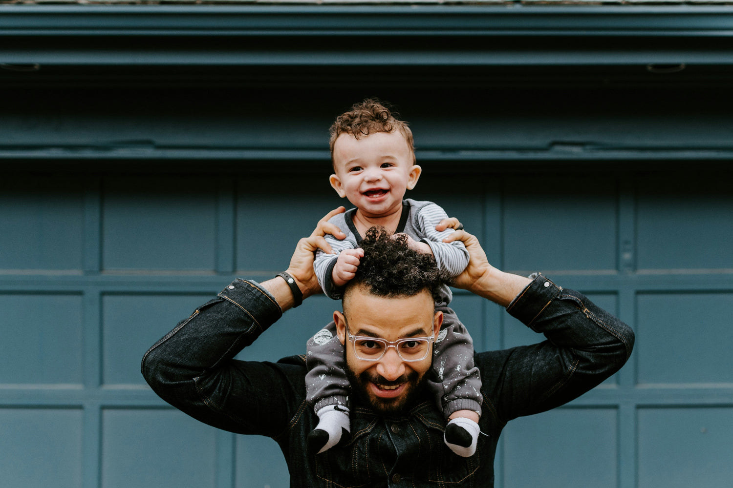 Toddler sits on man's shoulders