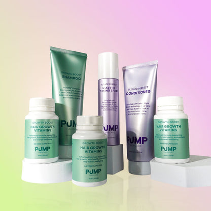 A set of hair growth products from PUMP Growth Body, including shampoo, conditioner, a spray, and two supplement bottles, arranged on white pedestals against a pastel gradient background.